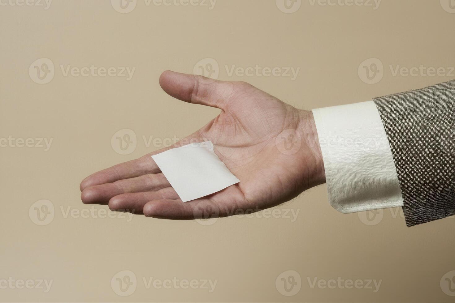 Hand holding a blank card against a neutral background, symbolizing opportunity and potential photo