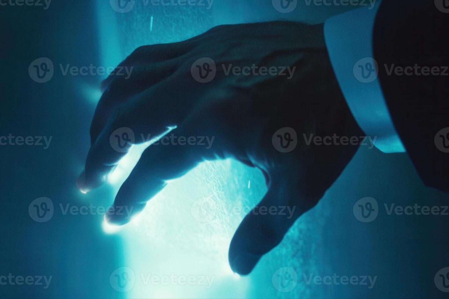 Hand reaching towards a glowing surface in a dimly lit environment, suggesting exploration photo