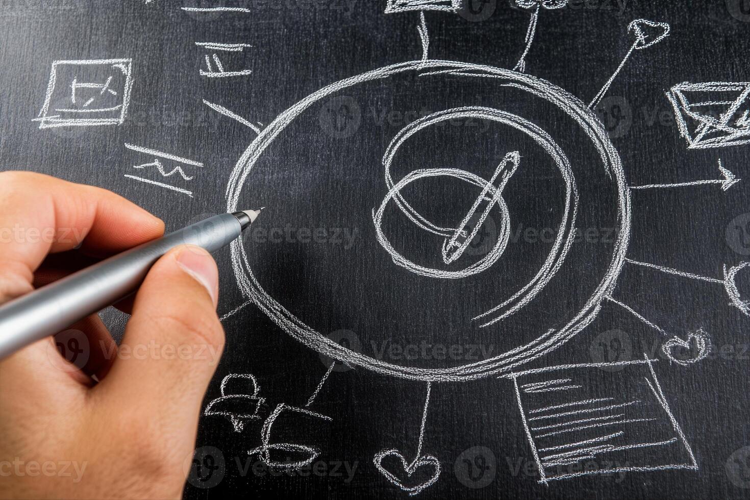 Hand holding a pen drawing diagrams on a chalkboard, illustrating creative brainstorming ideas photo