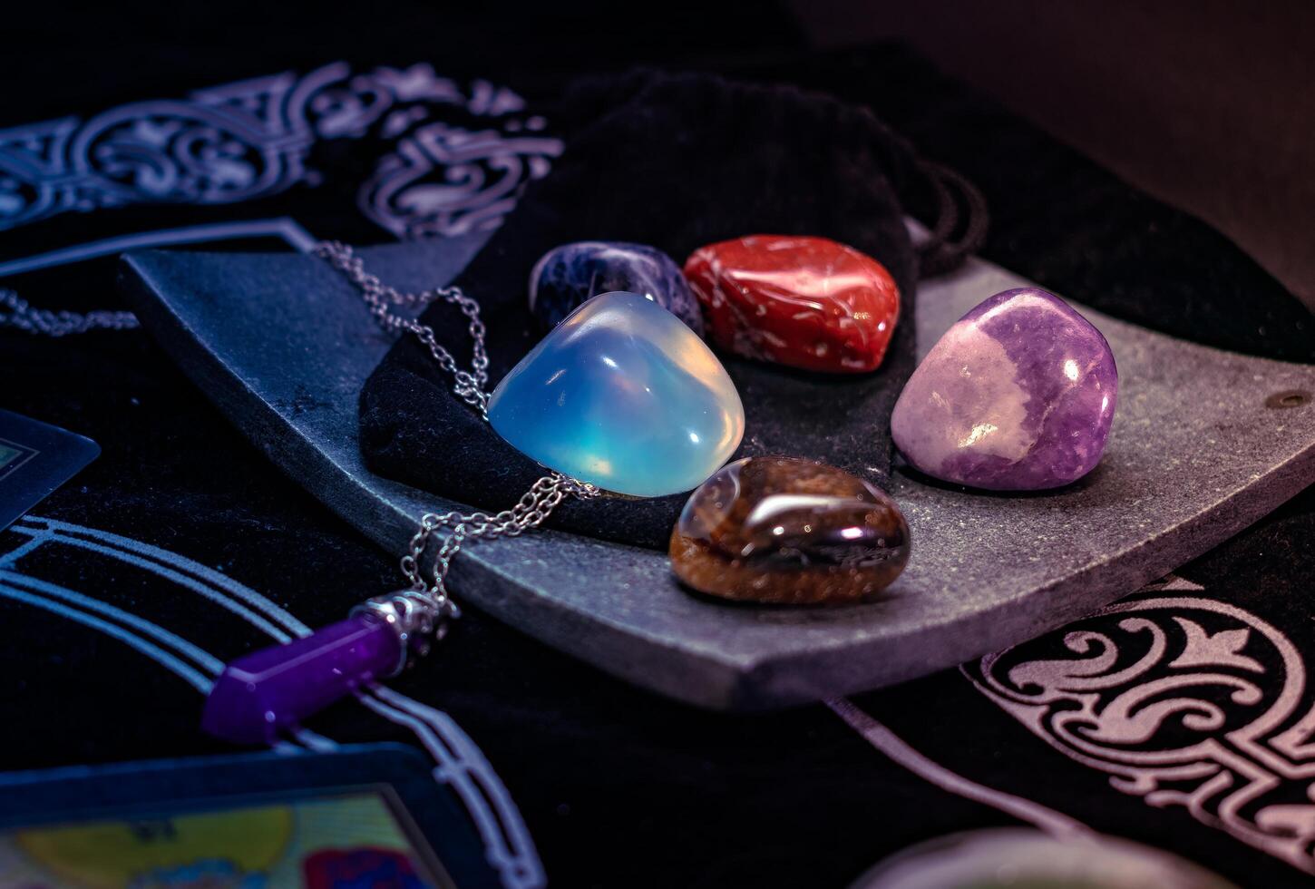 Polished healing crystals displayed on soft black velvet, spiritual and elegant photo