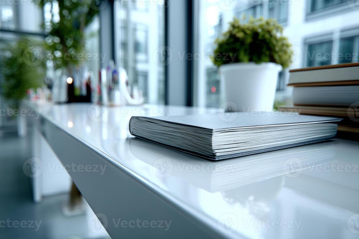 Notebook on a bright reflective surface near window light photo