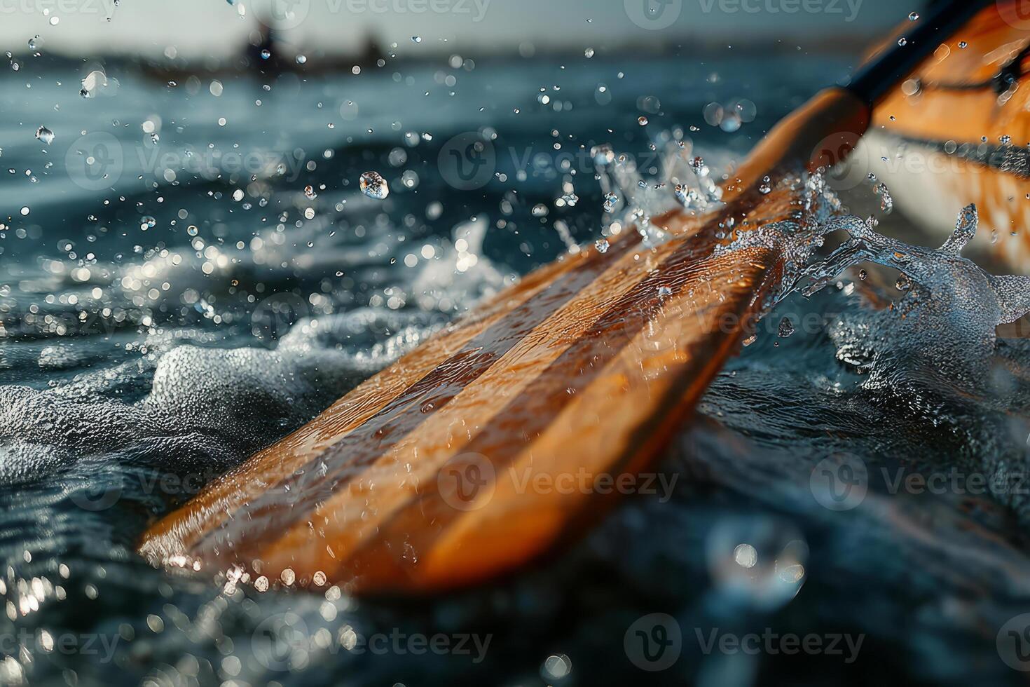 Wooden paddle splashing water during kayaking photo
