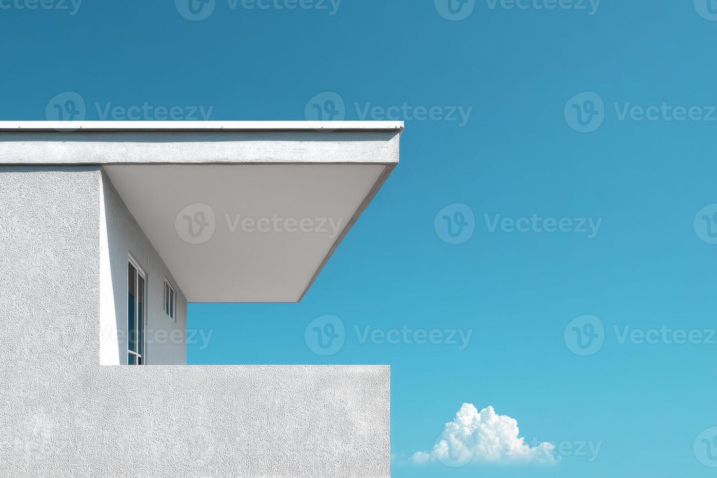 Modern building with clean lines and white overhang against blue sky photo