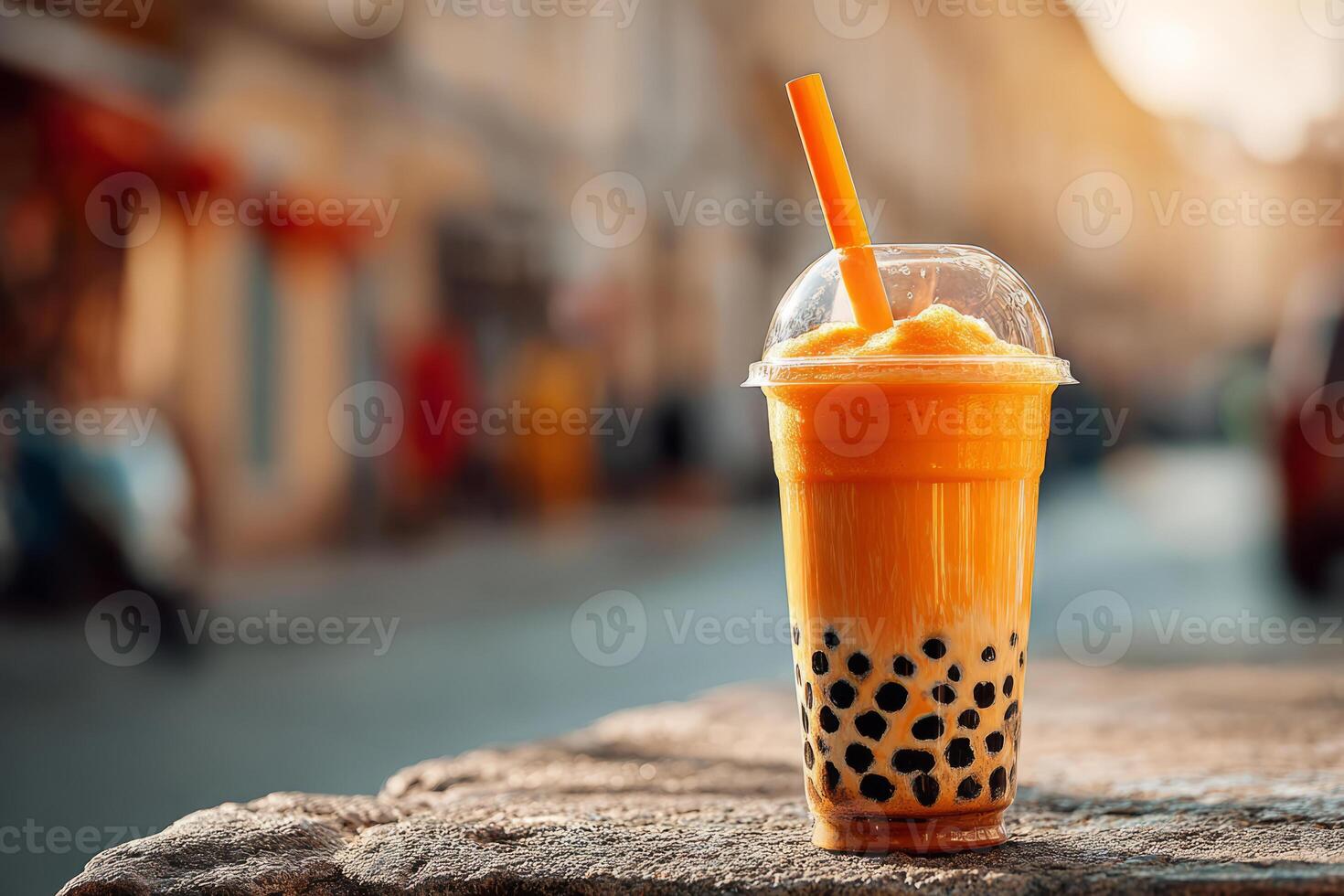 Mango bubble tea with tapioca pearls in plastic cup photo