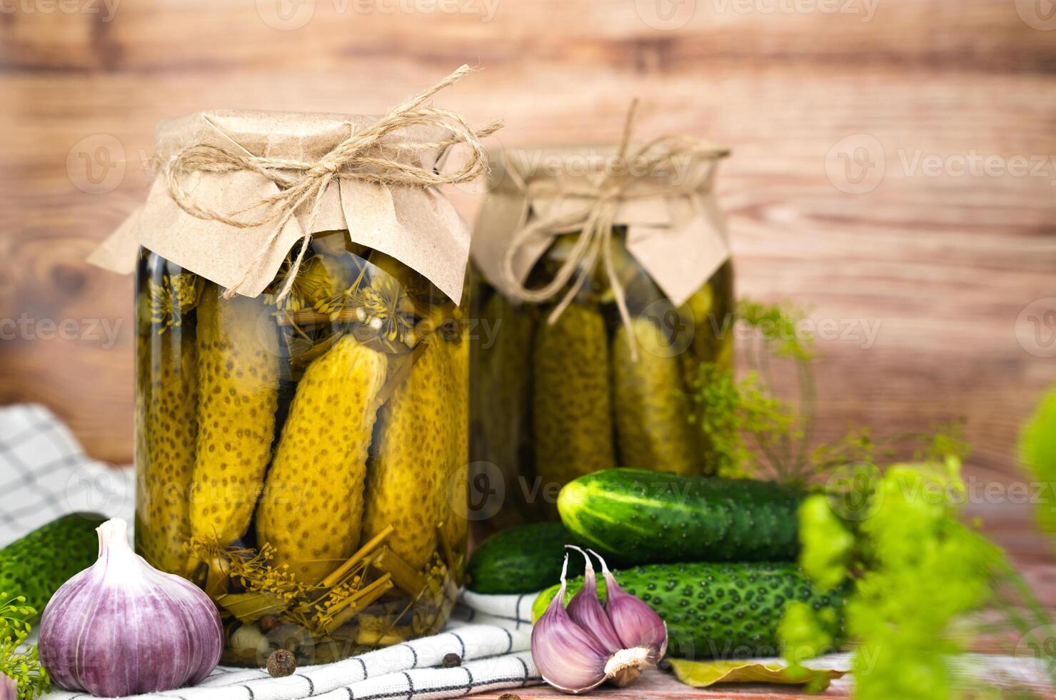 Delicious homemade pickled cucumbers in jars on the table. Close-up. Copy space. photo