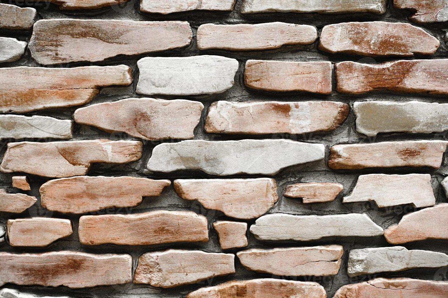 A stone wall. The texture of a large stone. Part of a building wall. Close-up. Copy space. photo