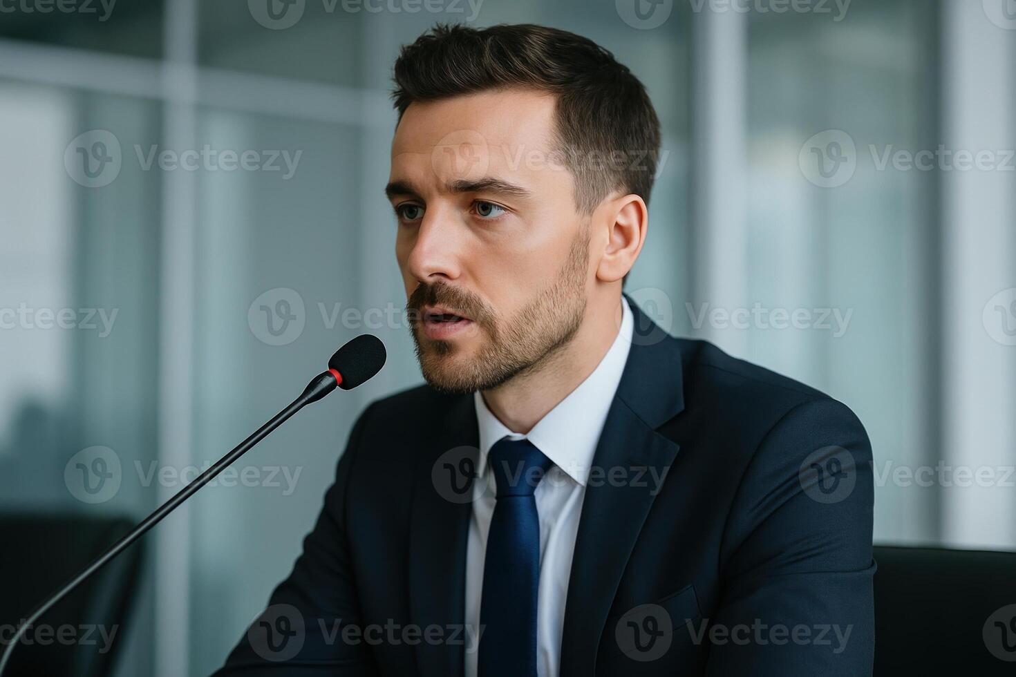 Businessman Speaking Into Microphone During Conference in Professional Setting photo