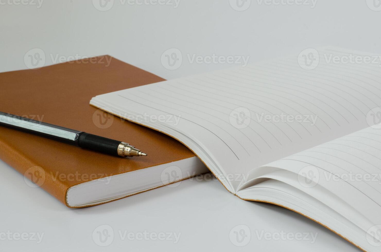 Leather Cover Notebook Open and Pen on White Background photo