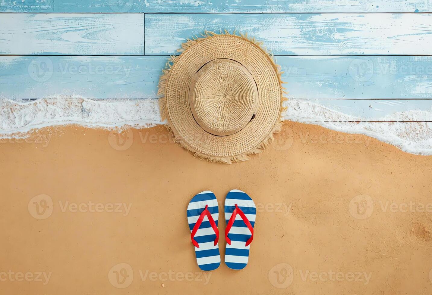 Summer Essentials Straw Hat and Striped Flip-Flops on Sandy Beach photo