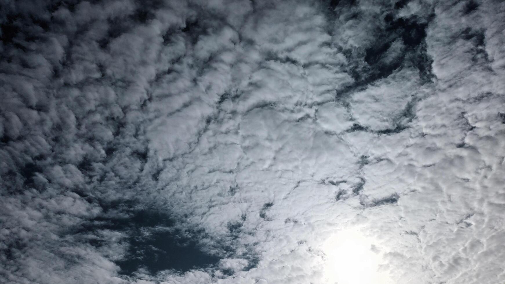 Textured clouds with bright sun photo