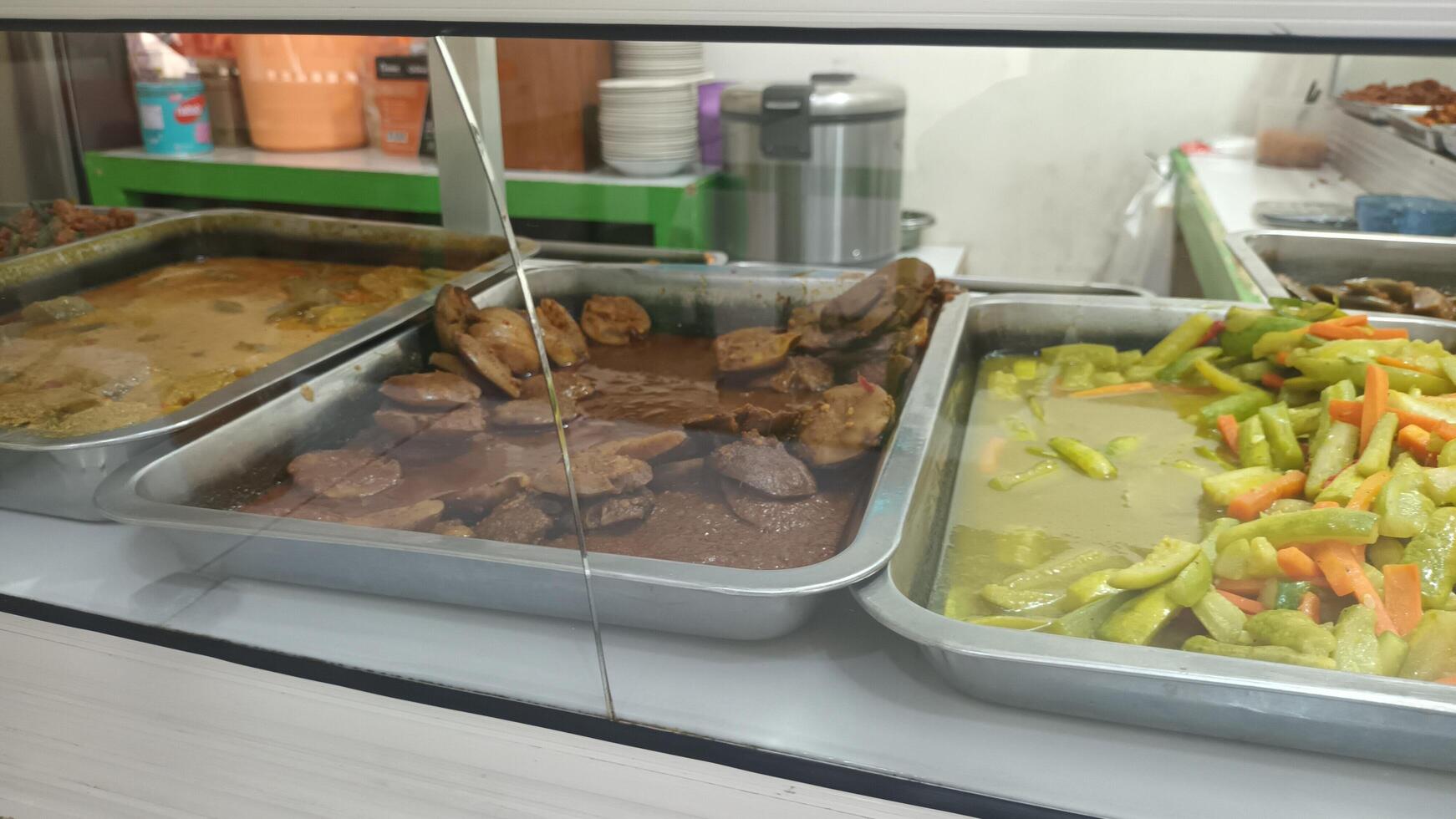 Various Indonesian dishes displayed for sale. photo
