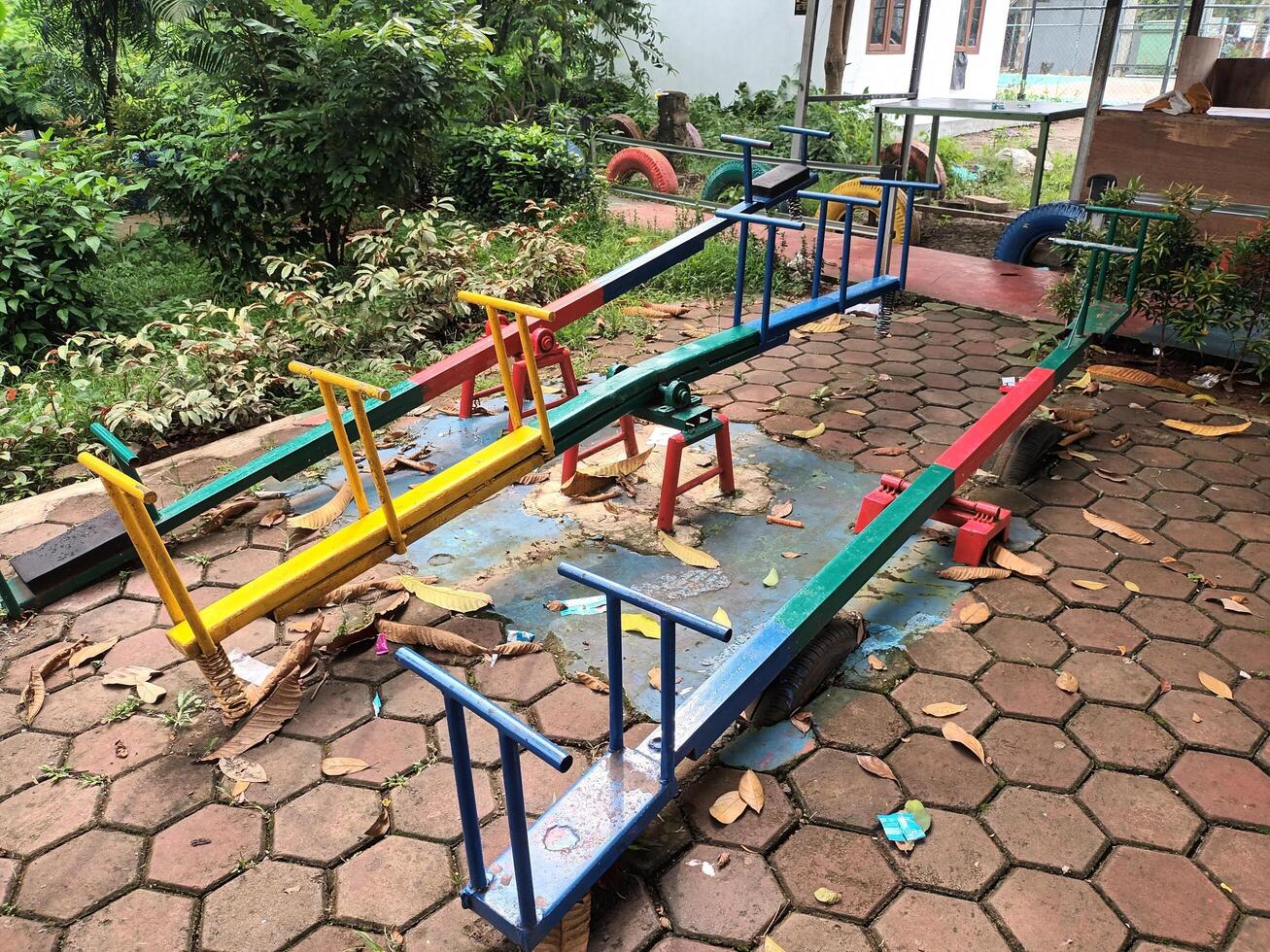 Colorful Seesaw Playground Equipment on a Paved Surface photo
