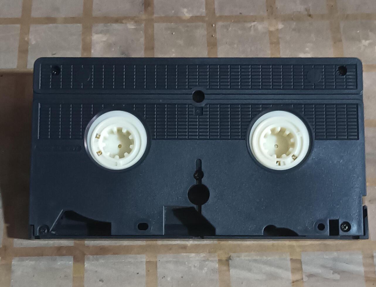 Black VHS Tape on a Checkered Surface photo