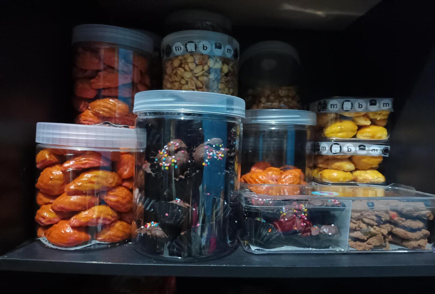 A shelf filled with jars of food and other items photo
