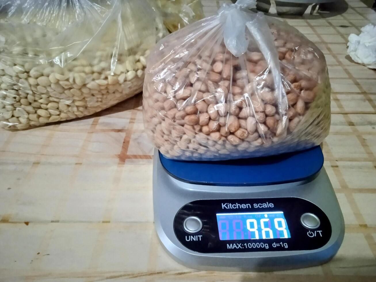 Bag of Peanuts Being Weighed on a Kitchen Scale. Location Bekasi, west java, indonesia. May 09 ' 2025 photo
