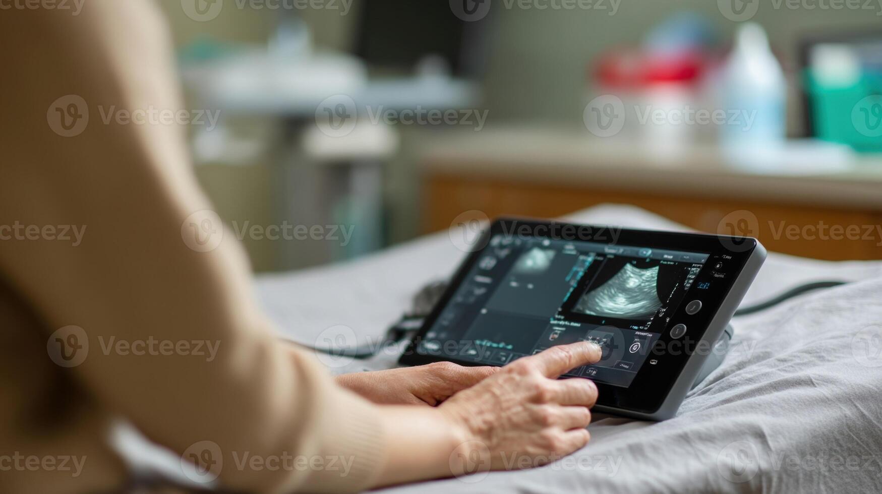 A portable ultrasound device is being used at a bedside displaying realtime images of a patients abdominal structures on a clear touchscreen interface photo
