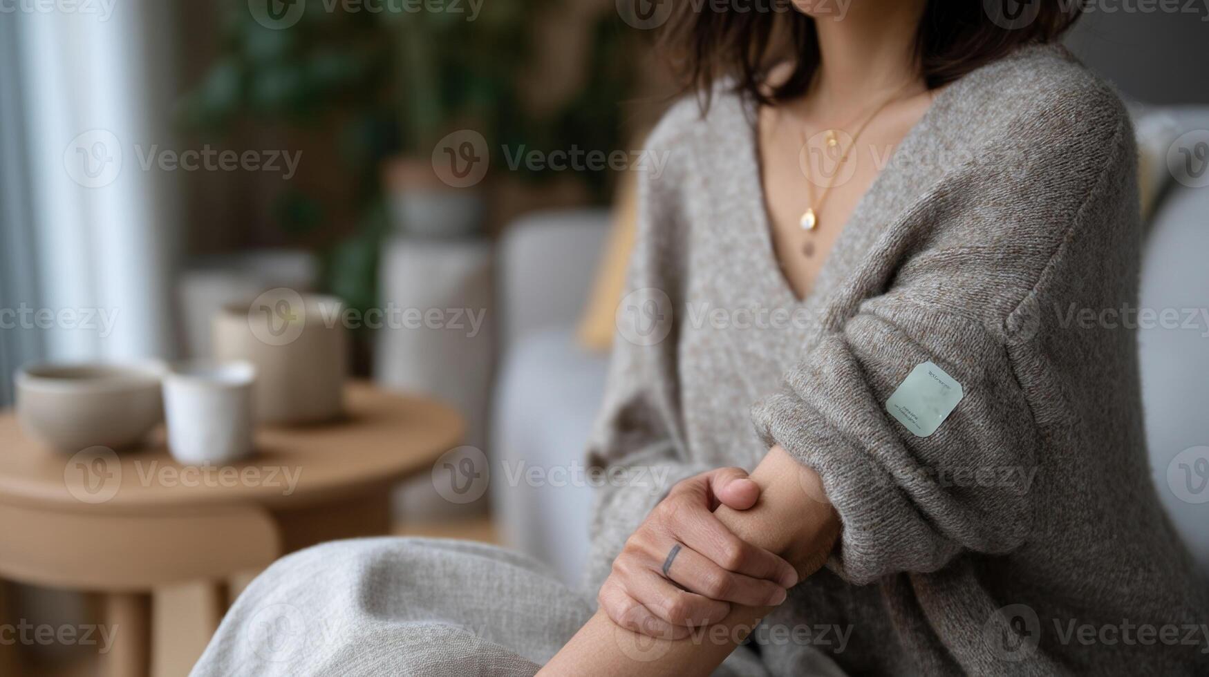 A wearable patch on a users arm capturing glucose levels and hydration status depicted in a cozy home environment showcasing the blend of technology and everyday life without compromisin photo