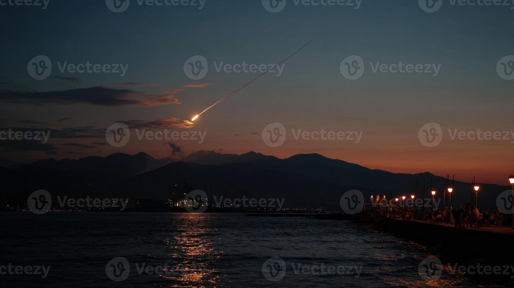 Meteor falling from the sky at sunset over the sea photo