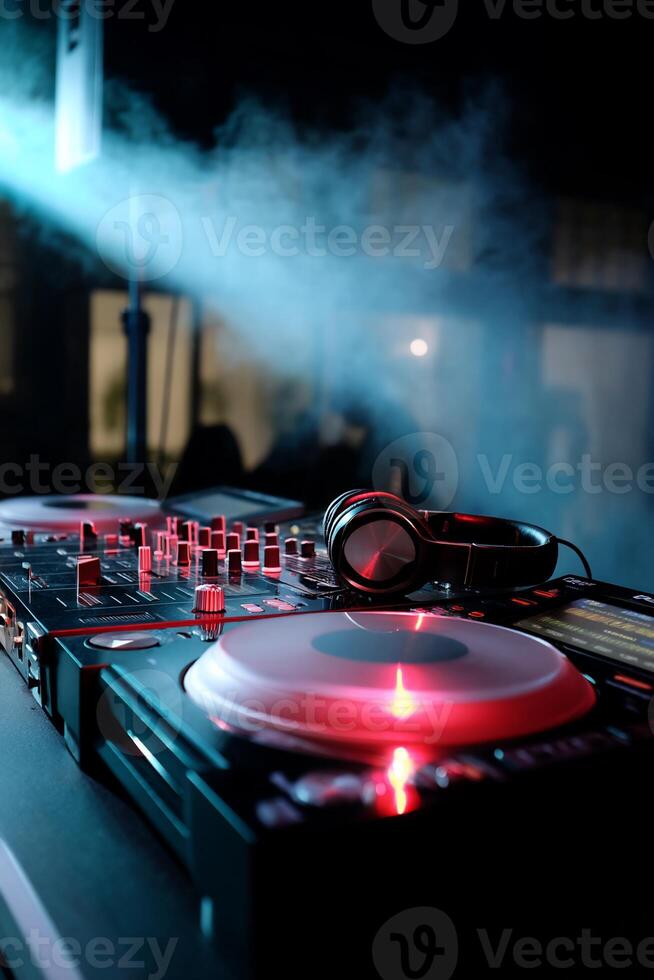 DJ equipment glows in smoky club photo