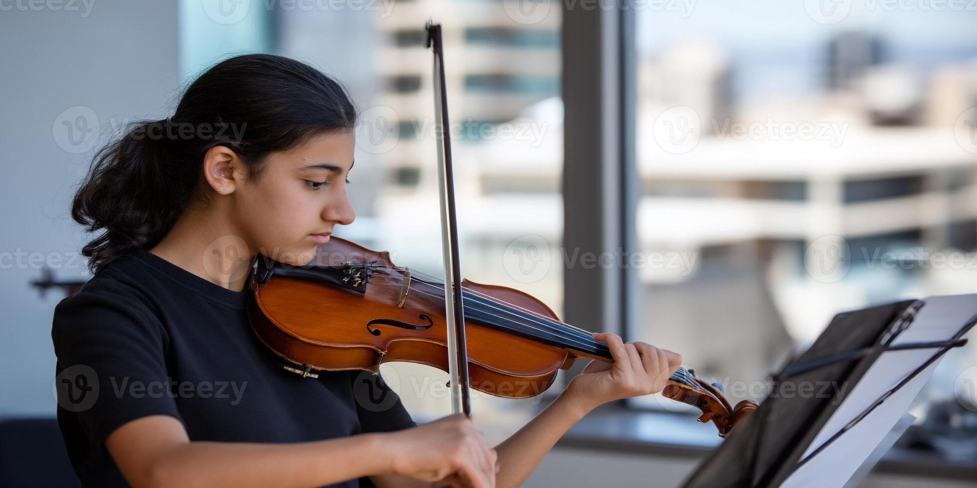 Young girl plays violin photo