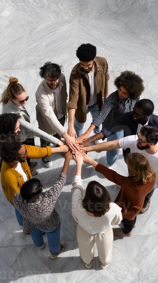 Diverse group hands clasped in circle, united photo