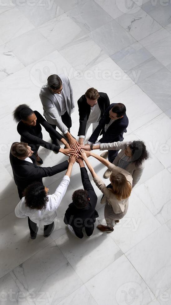 Diverse business team united in circle. Hands clasped together, showing teamwork and collaboration photo