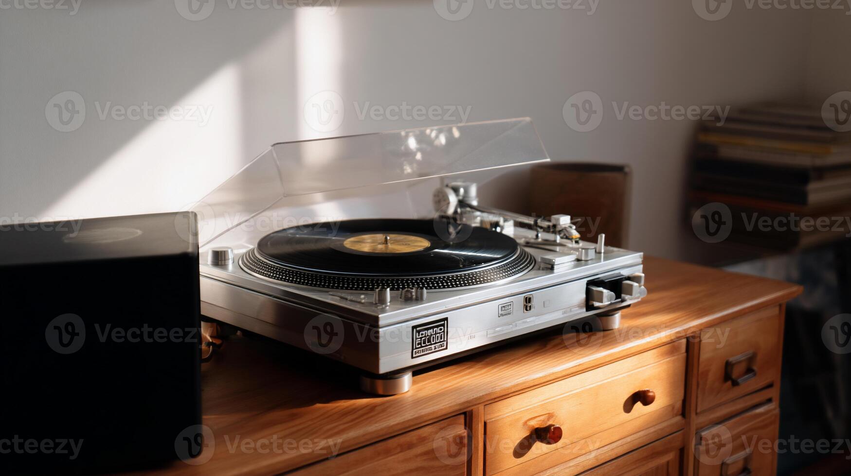 Stylish turntable on a wooden cabinet, bathed in sunlight. A clear cover protects the record player. Bookshelves in the background photo