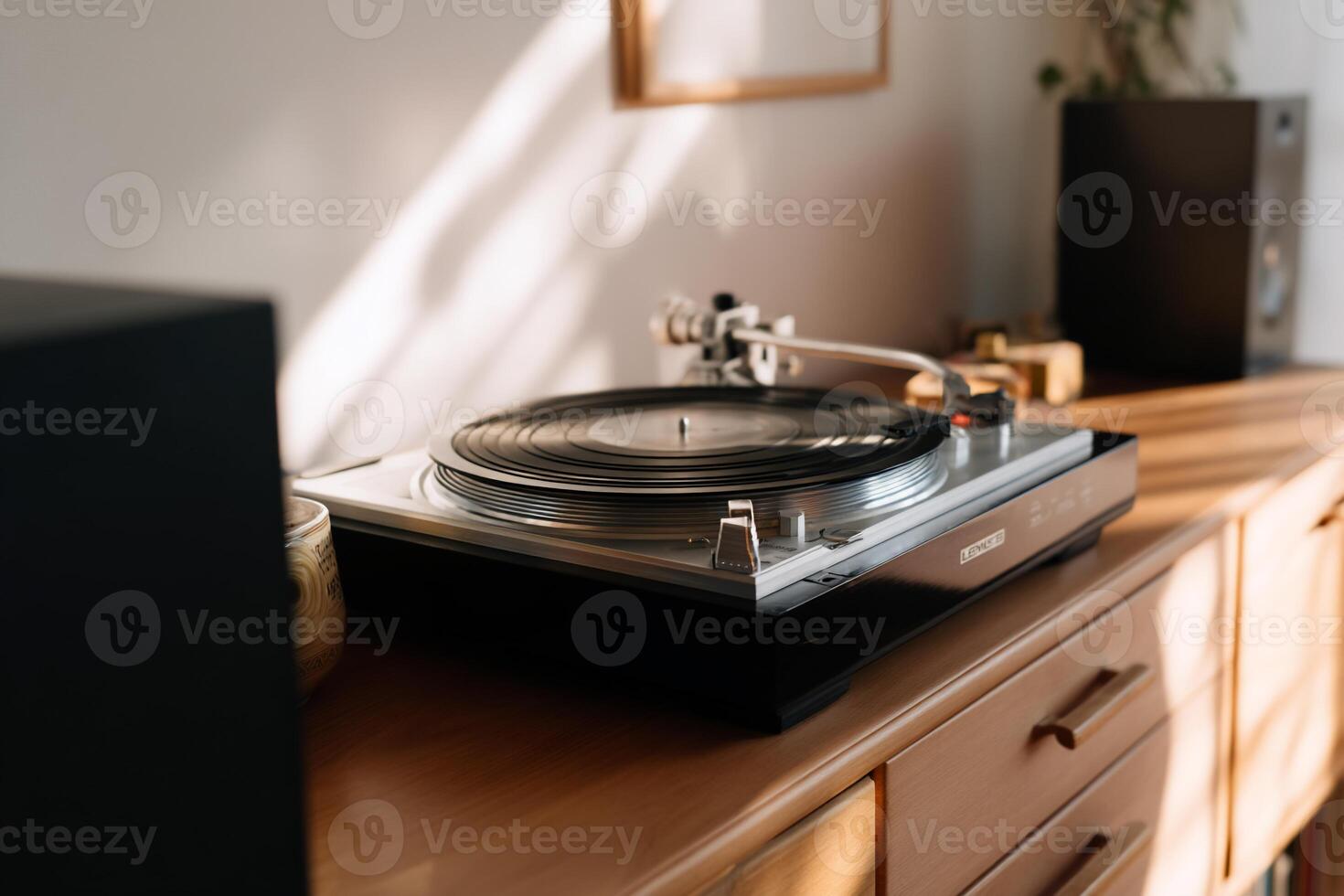 A turntable sits on top of a wooden table photo
