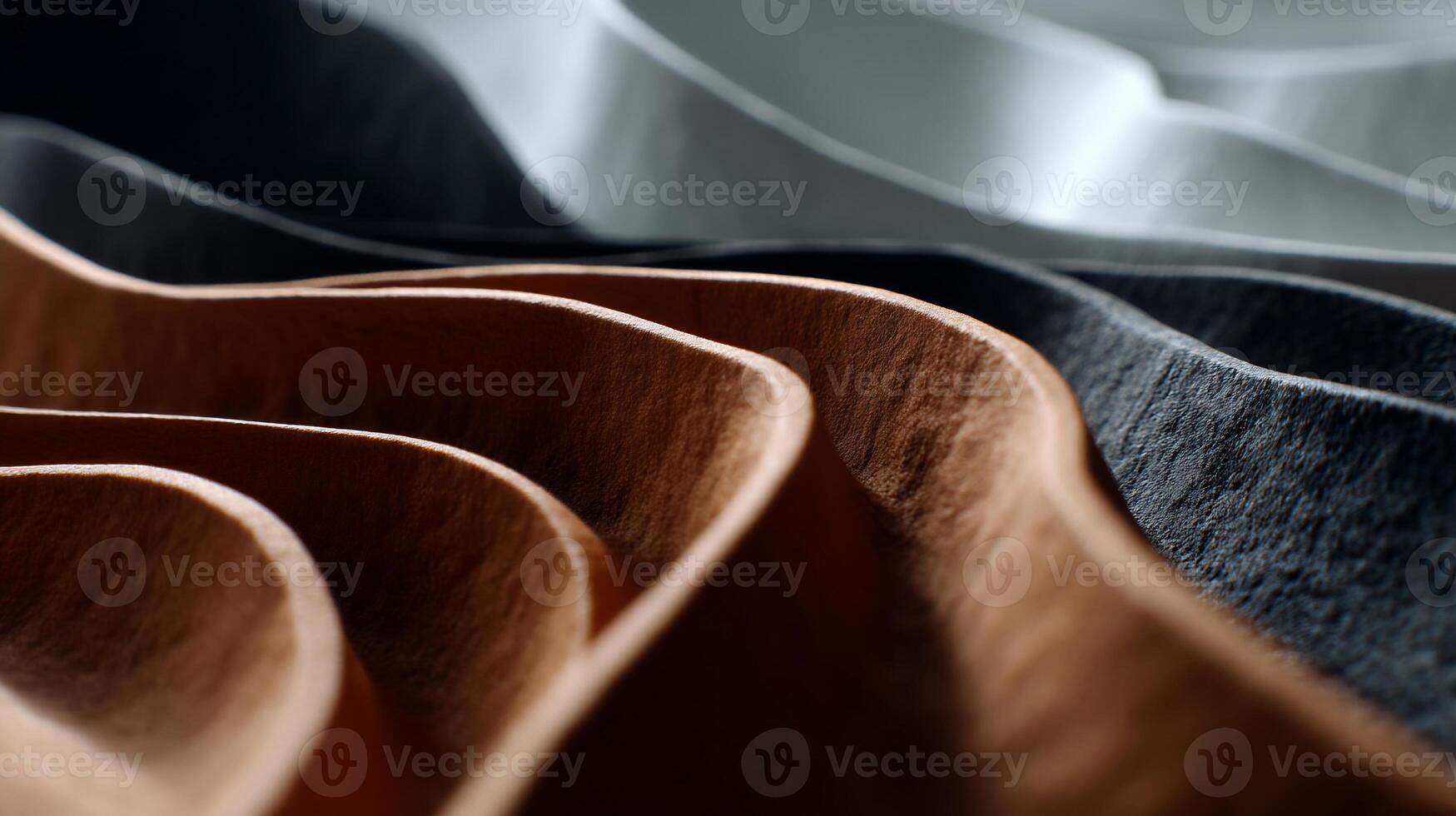 Abstract, layered, textured folds in various shades of brown, gray, and white. Close-up view showcasing deep, undulating patterns photo
