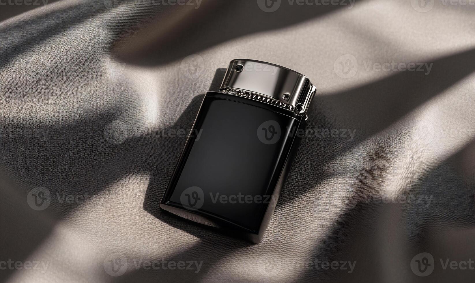A black and silver lighter sitting on a bed photo