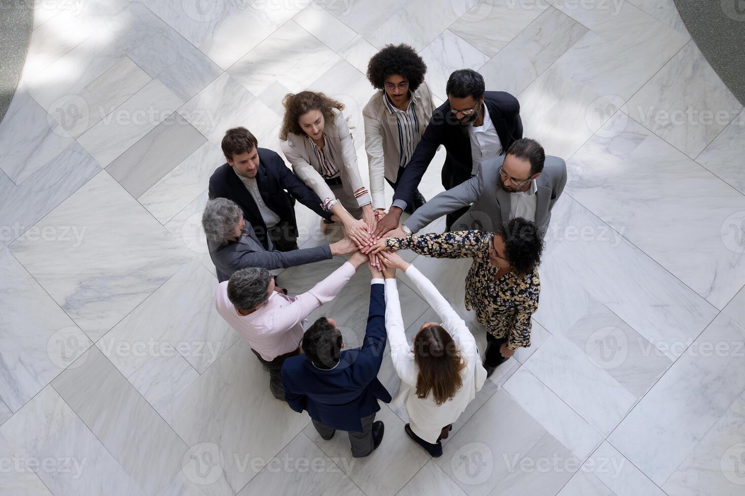 Diverse team united in a circle, hands clasped together photo