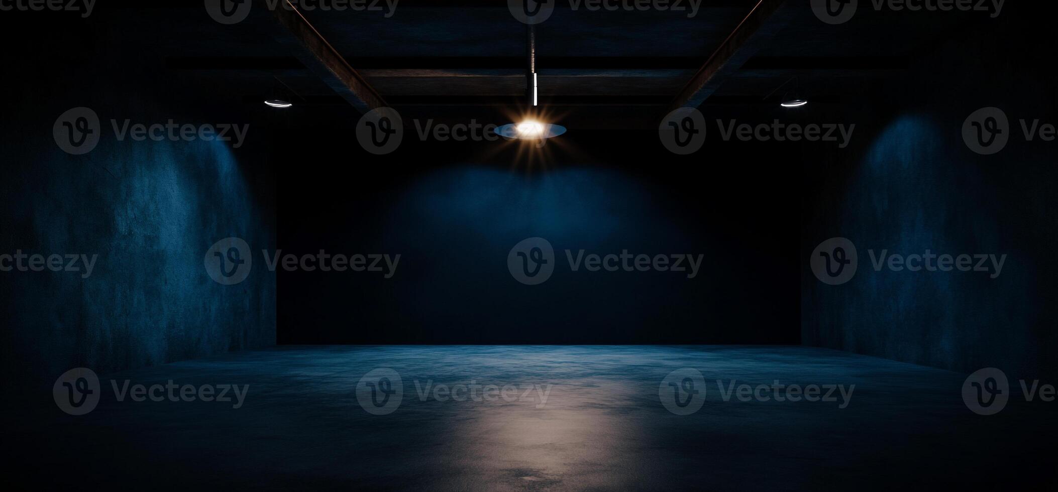 Dark, empty, industrial space with single light source photo