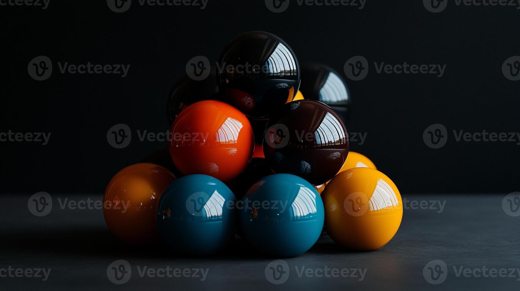 Colorful billiard balls stacked in a pyramid shape on a dark surface photo