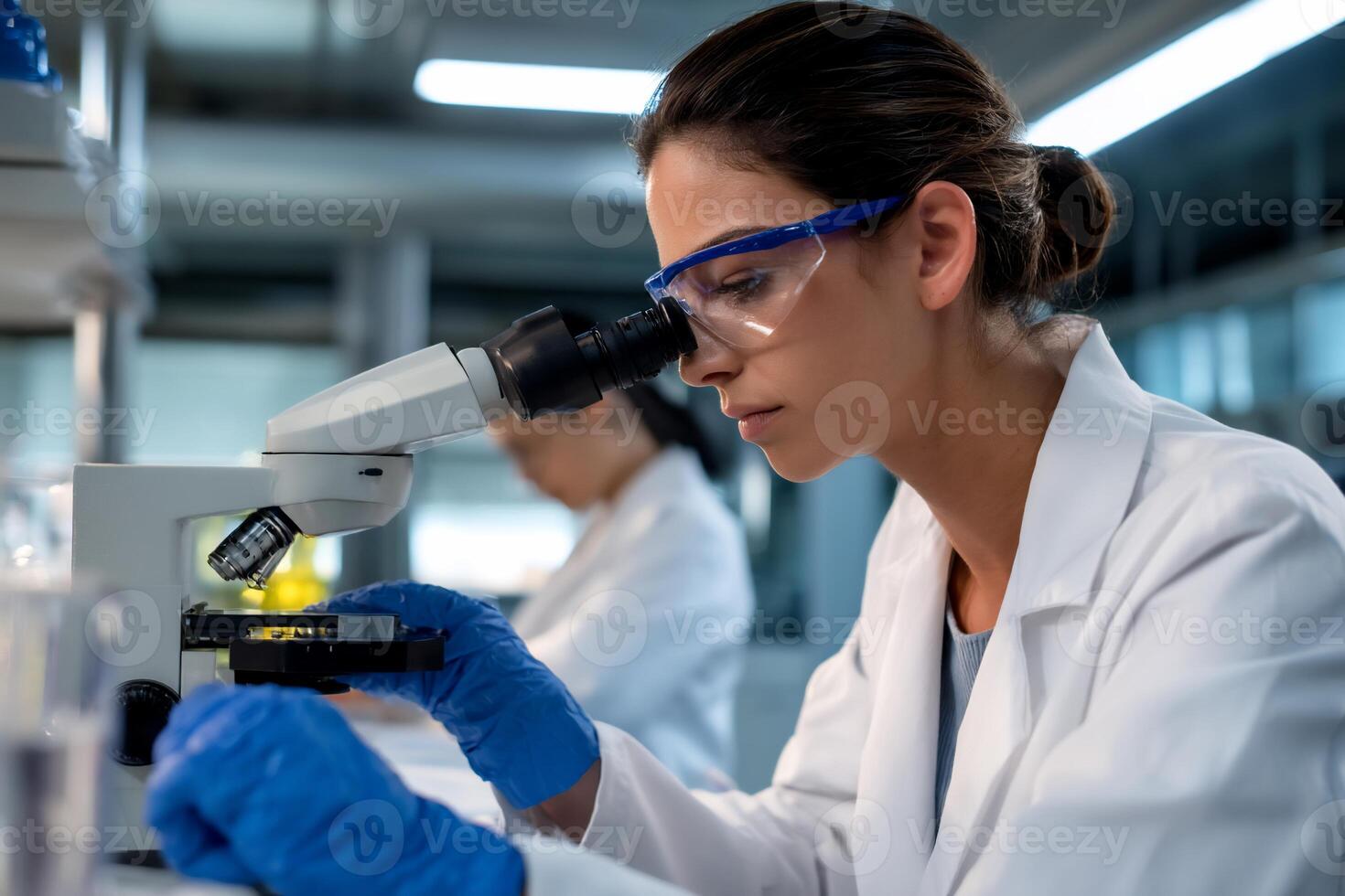 Focused scientist examining sample under microscope in lab setting photo