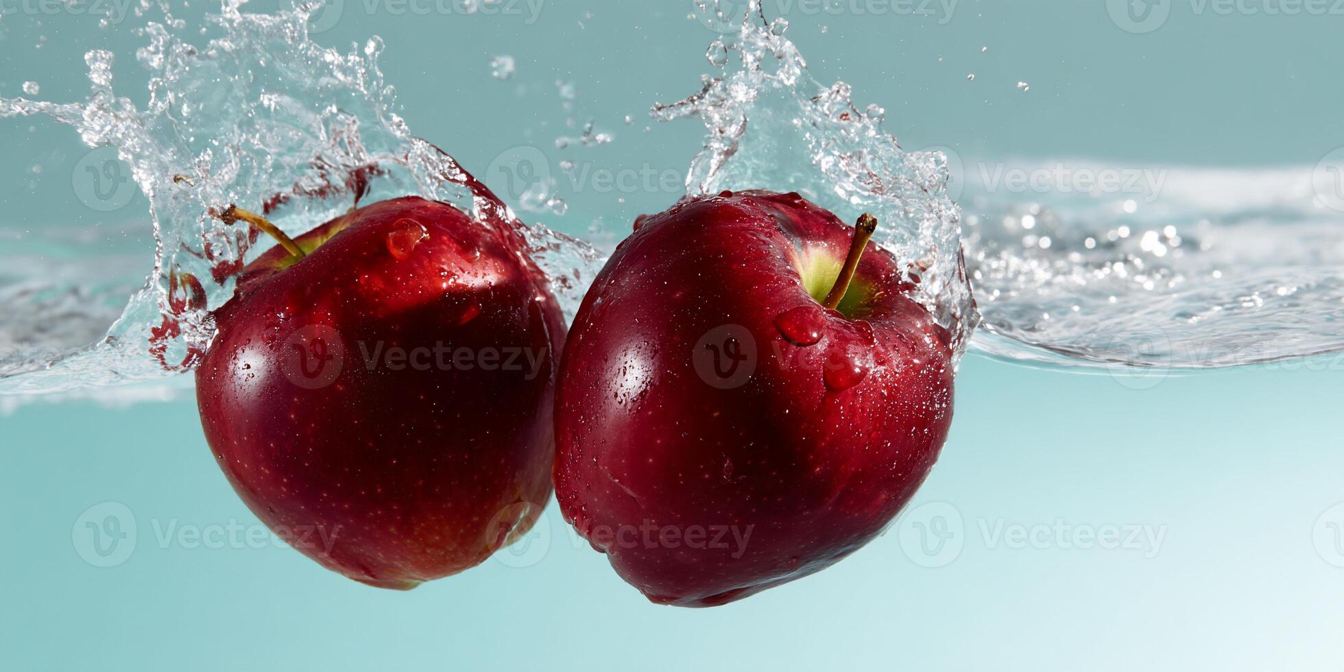 Two red apples are splashing in water photo