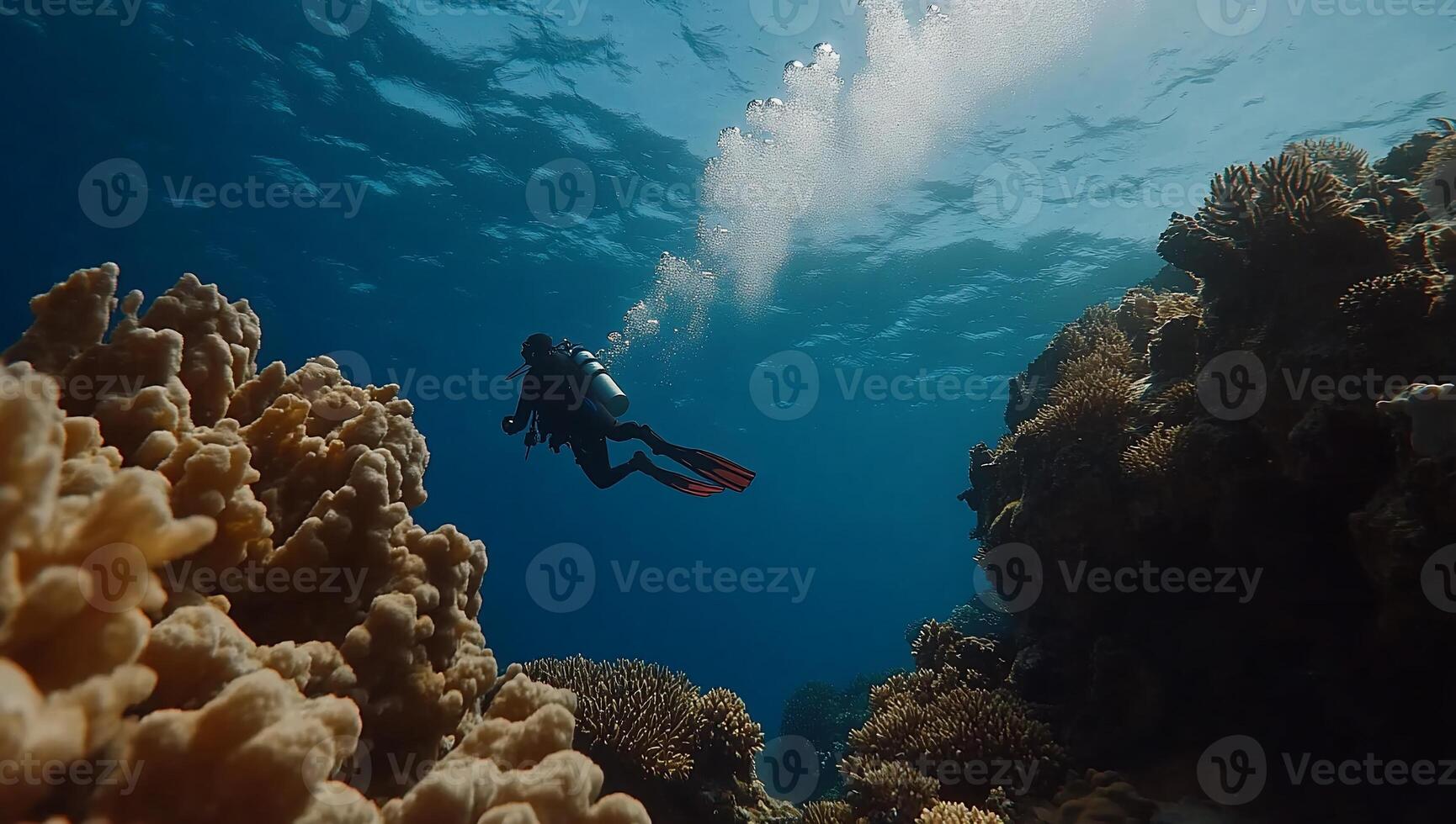 Underwater diver explores vibrant coral reef. Sunlight streams through the water, illuminating the coral formations and the diver's equipment photo