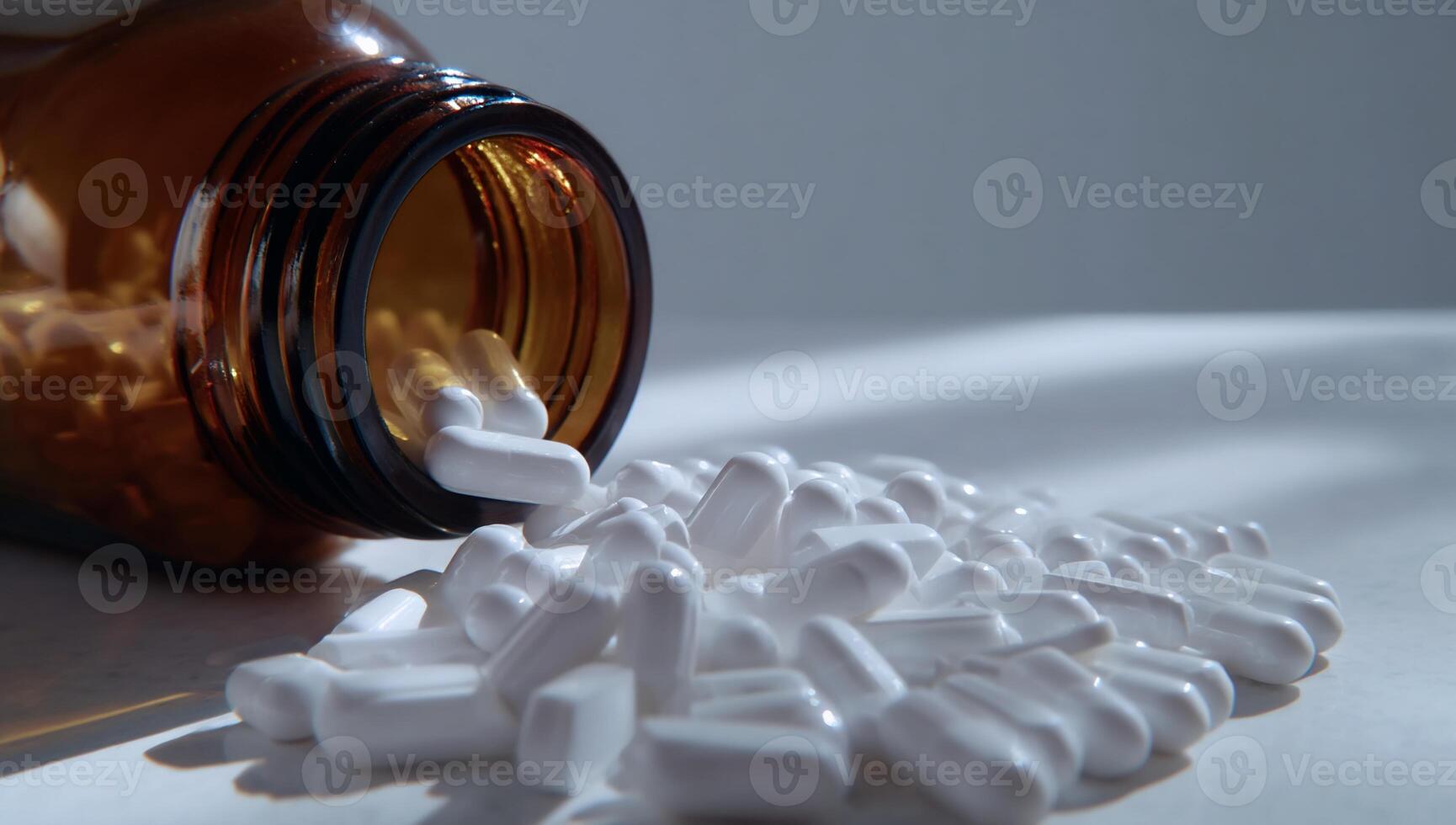 A bottle of pills spilling out onto a table photo