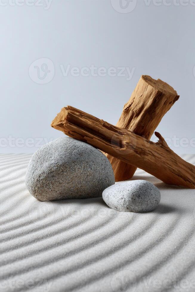 Wooden logs and stones on a sand surface. Muted tones of light brown and gray on white photo