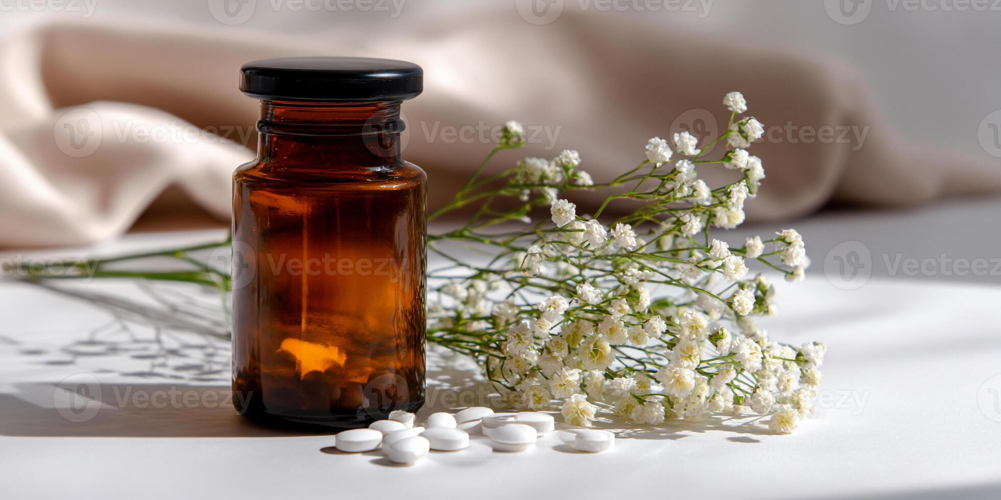 Brown bottle with white pills and delicate flowers photo