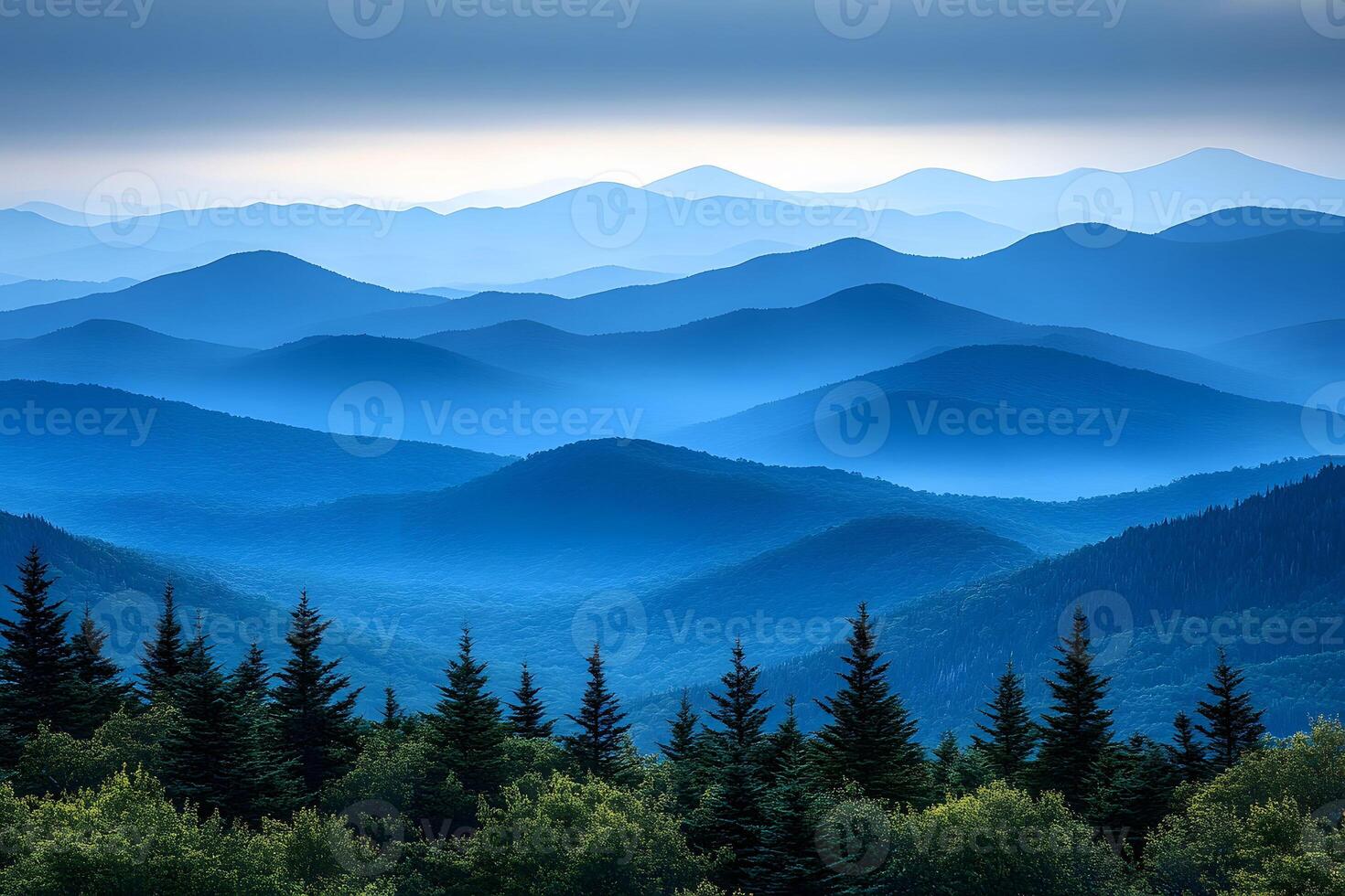 Serene Mountain Landscape with Blue Misty Ridges and Evergreen Forests photo