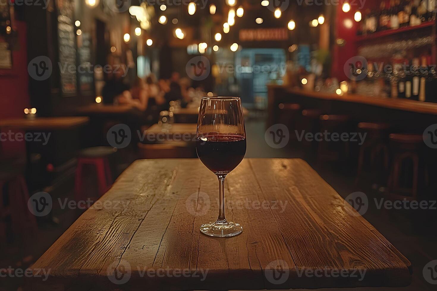 Cozy Wine Bar Ambiance with Glass of Red Wine on Wooden Table photo
