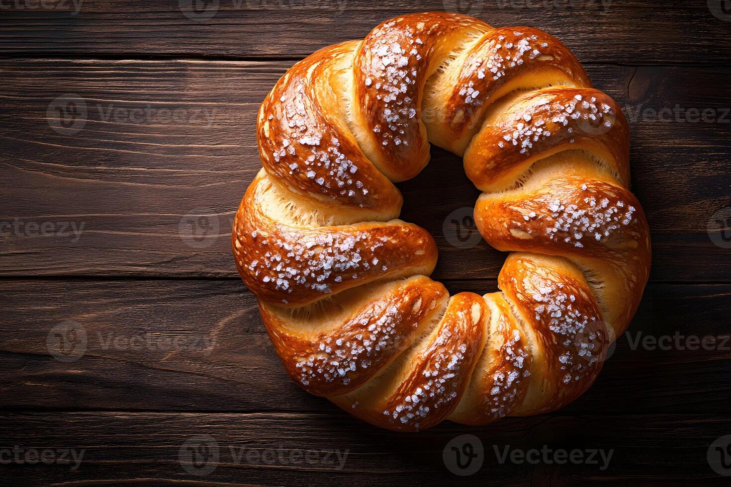 Freshly Baked Twisted Sweet Bread with Sugar Crystals on Rustic Wood Background photo