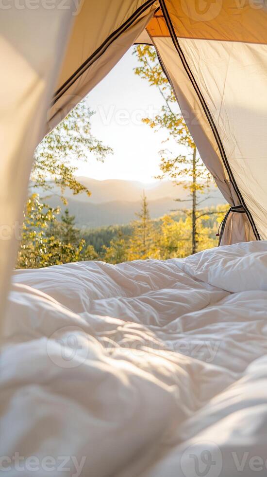 Mountain plush interior featuring tent bedding, soft morning light illuminating rugged peaks through canvas opening photo