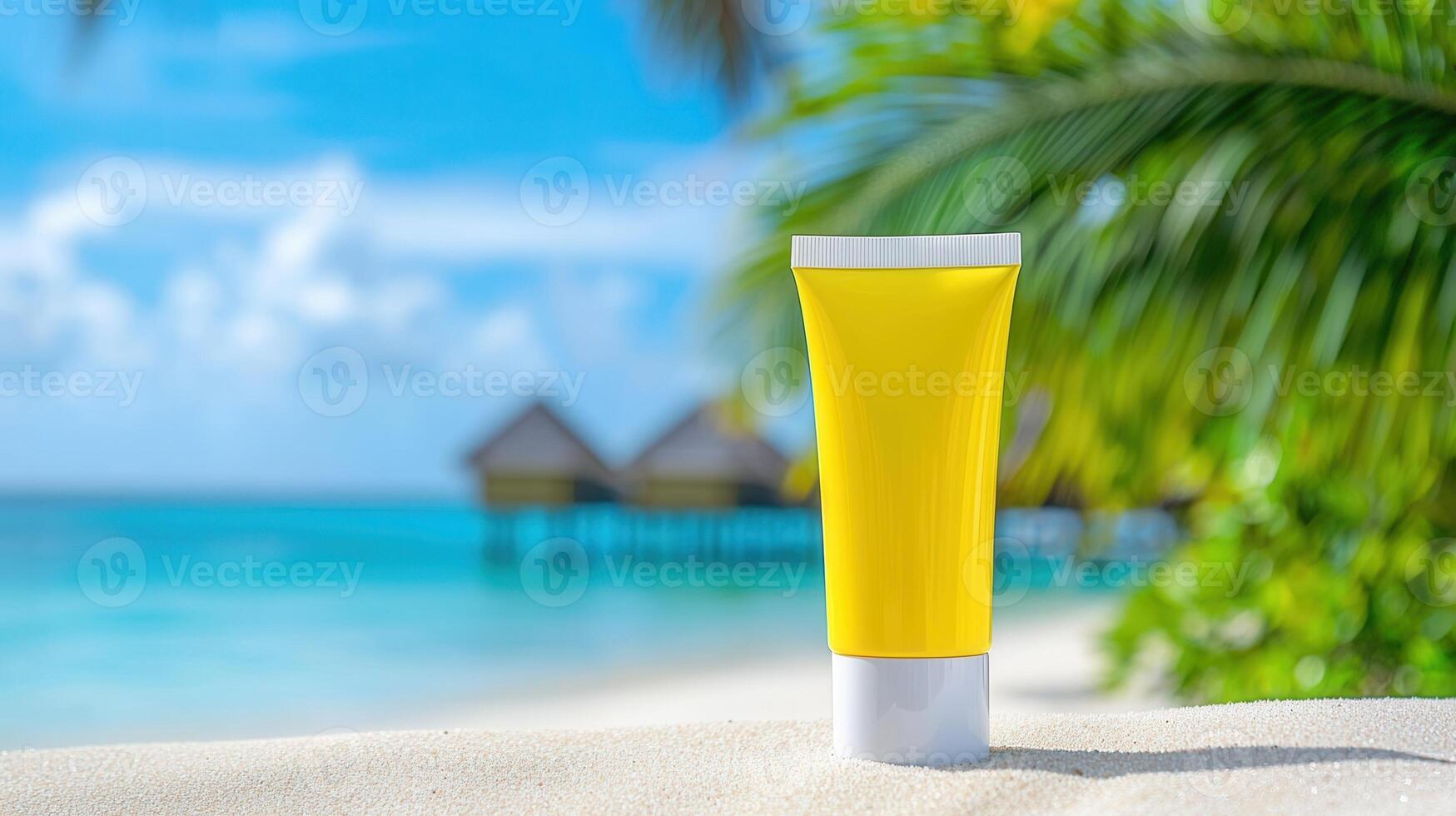 Yellow sunscreen bottle standing on white sand beach with tropical palm leaves and turquoise background in sea photo
