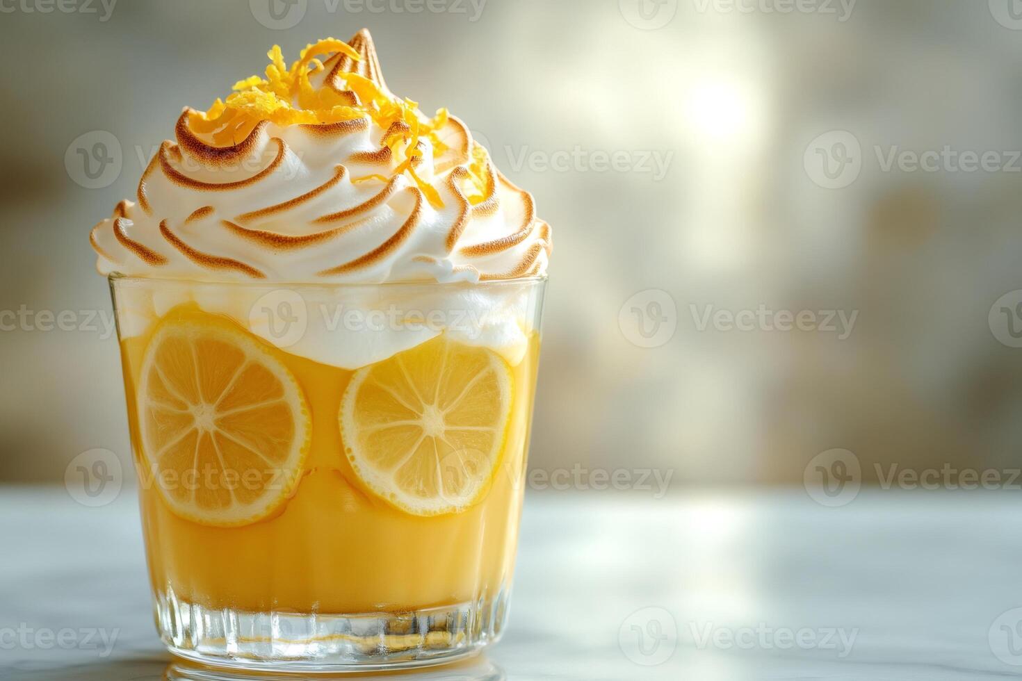 Lemon posset dessert garnished with meringue and lemon zest photo