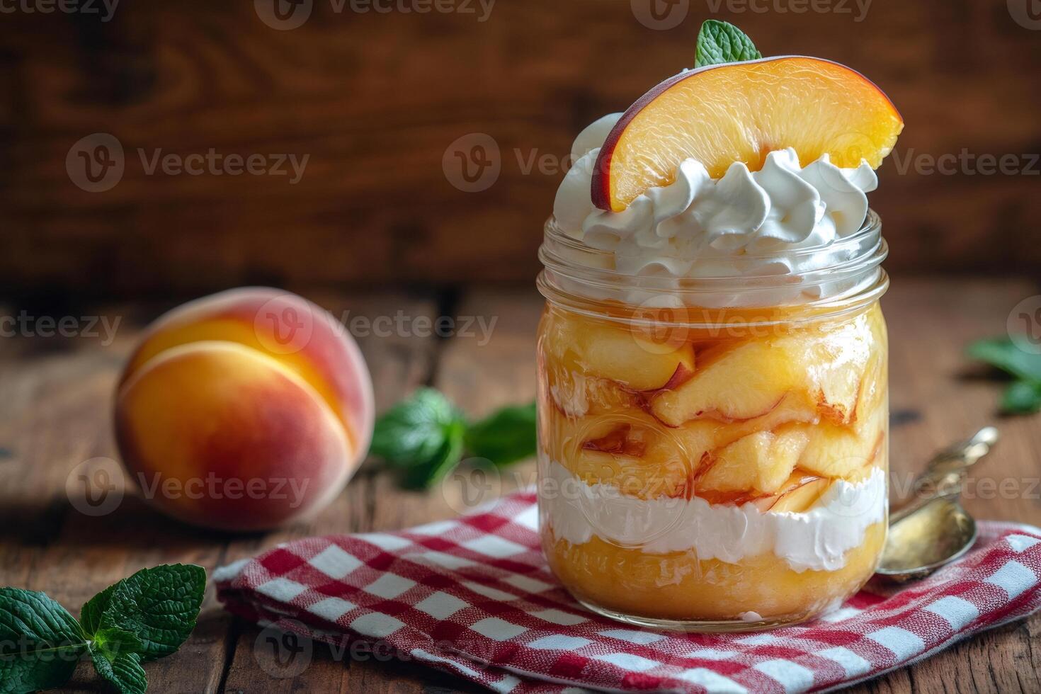 Peach dessert layered with whipped cream and biscuit in a jar on rustic wooden table photo