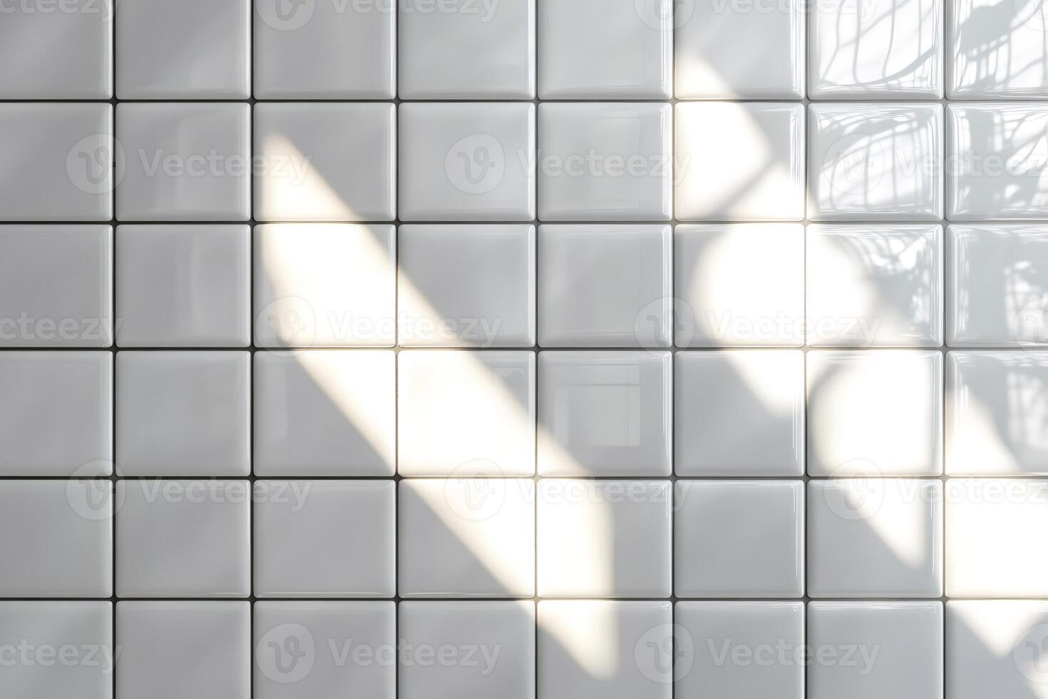 Sunlight creating shadows on white square tiles wall photo