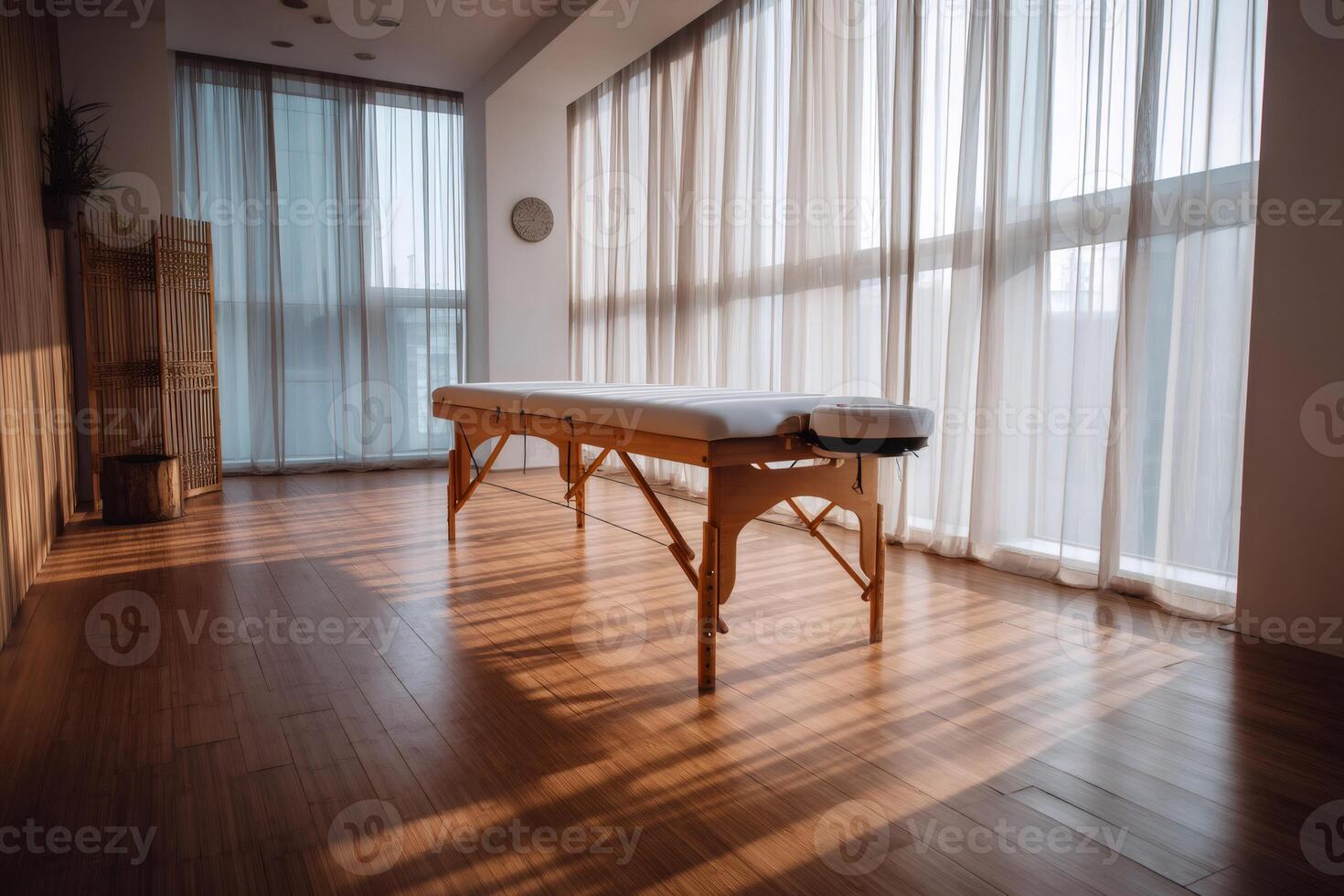 Empty massage table stands in room with sunlight streaming through window photo