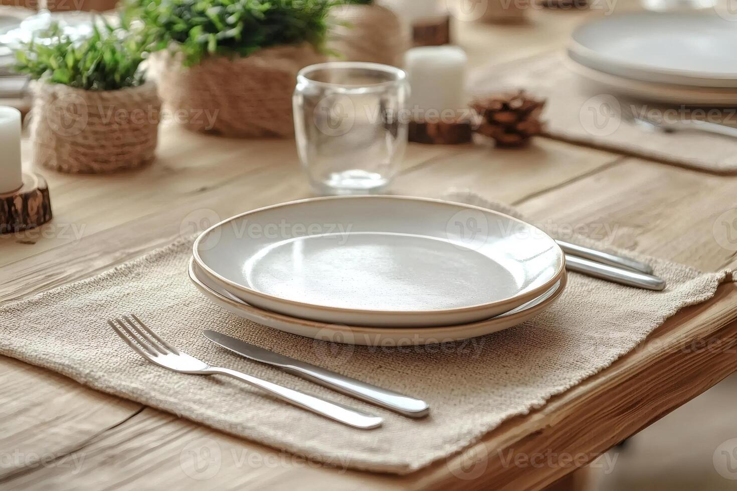 Table setting featuring rustic placemats, empty plates, and festive decorations photo