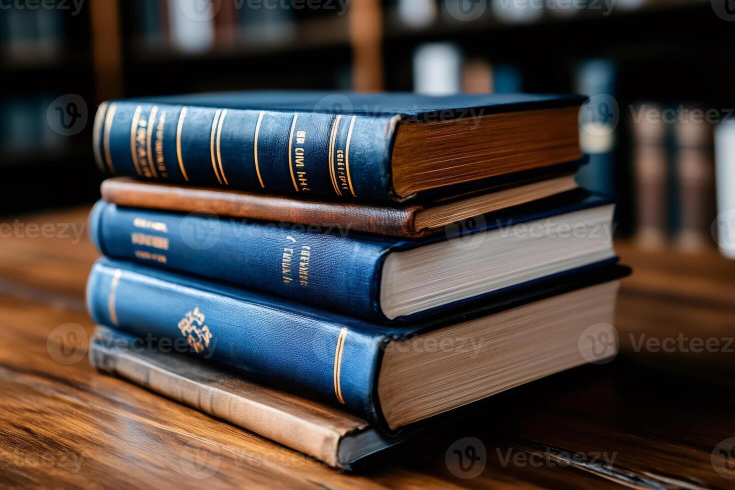Stack of old books lying on wooden table in library photo
